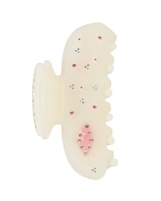 Cream-colored hair clip with decorative elements on a white background