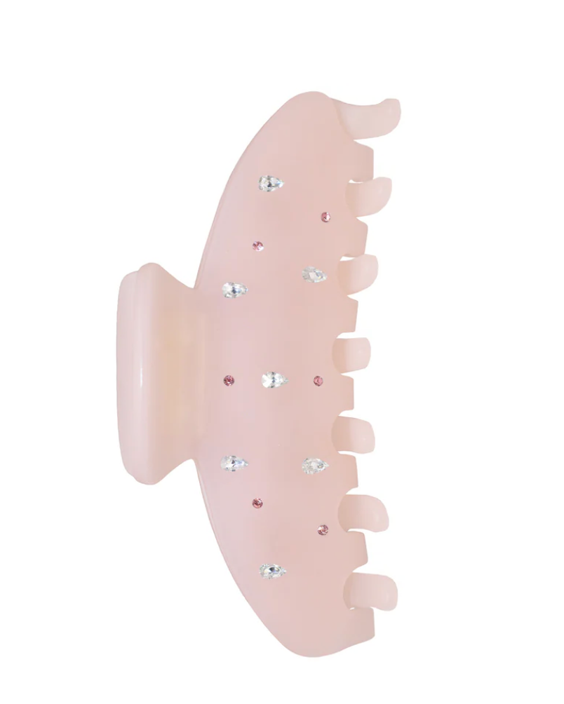 Pink hair clip with rhinestones on a white background