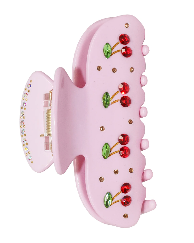 Pink hair clip with cherry design on a white background