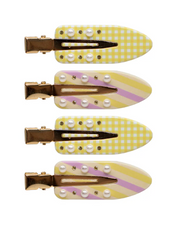 Set of four yellow and white checkered hair clips with pearl-like embellishments on a white background
