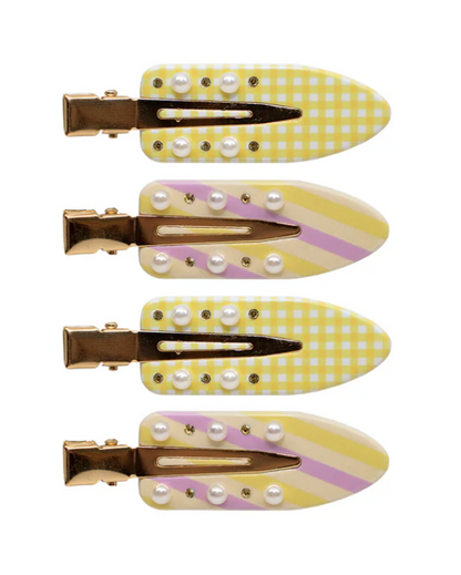 Set of four yellow and white checkered hair clips with pearl-like embellishments on a white background