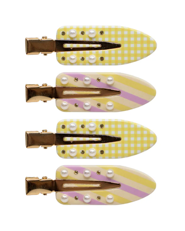 Set of four yellow and white checkered hair clips with pearl-like embellishments on a white background