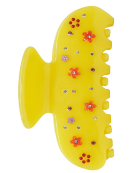 Yellow fish-shaped toy with decorative flowers on a white background