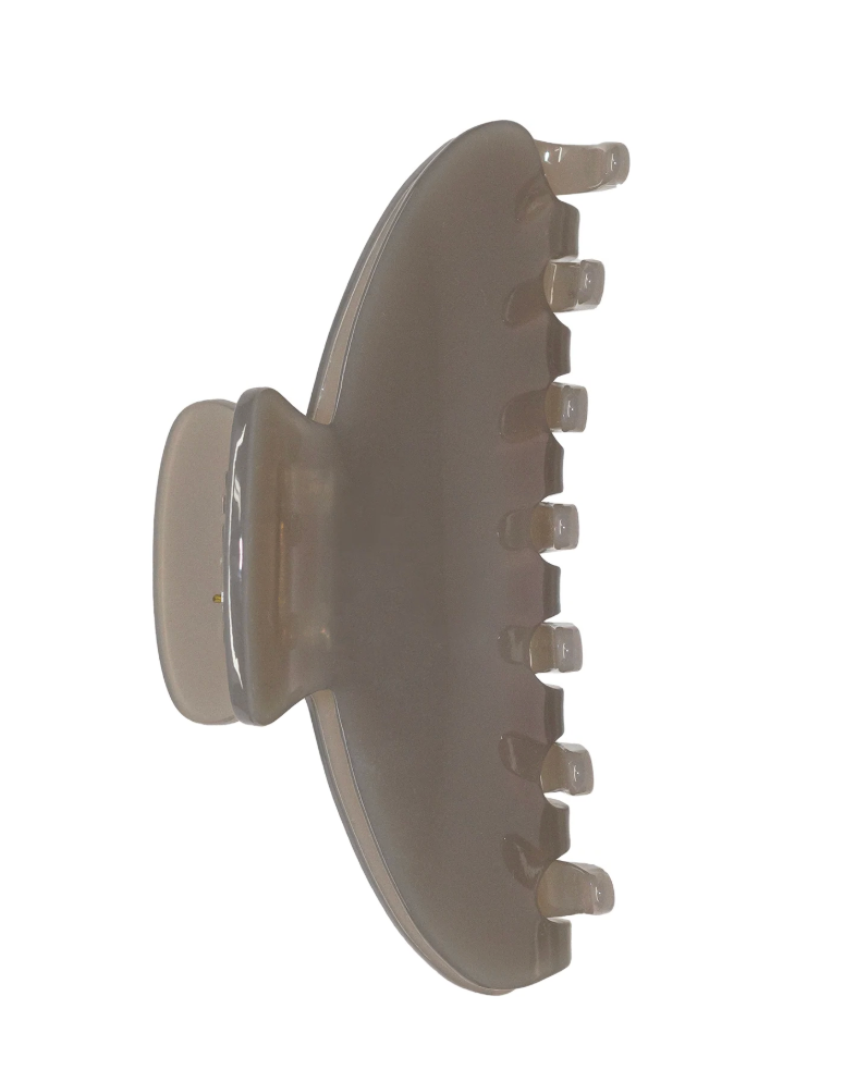 A translucent plastic claw hair clip in a light taupe-brown color, shown against a plain white background.