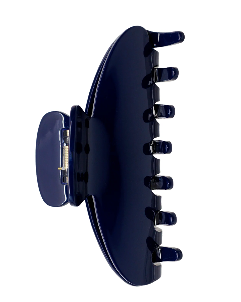 A glossy dark navy blue hair claw clip shown from the side against a plain white background.