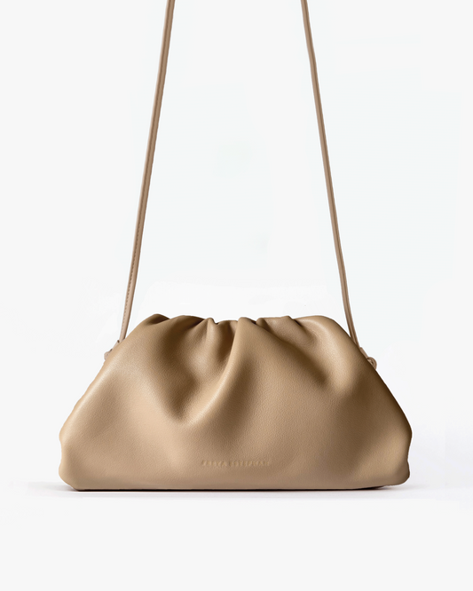 Beige handbag with a strap on a white background