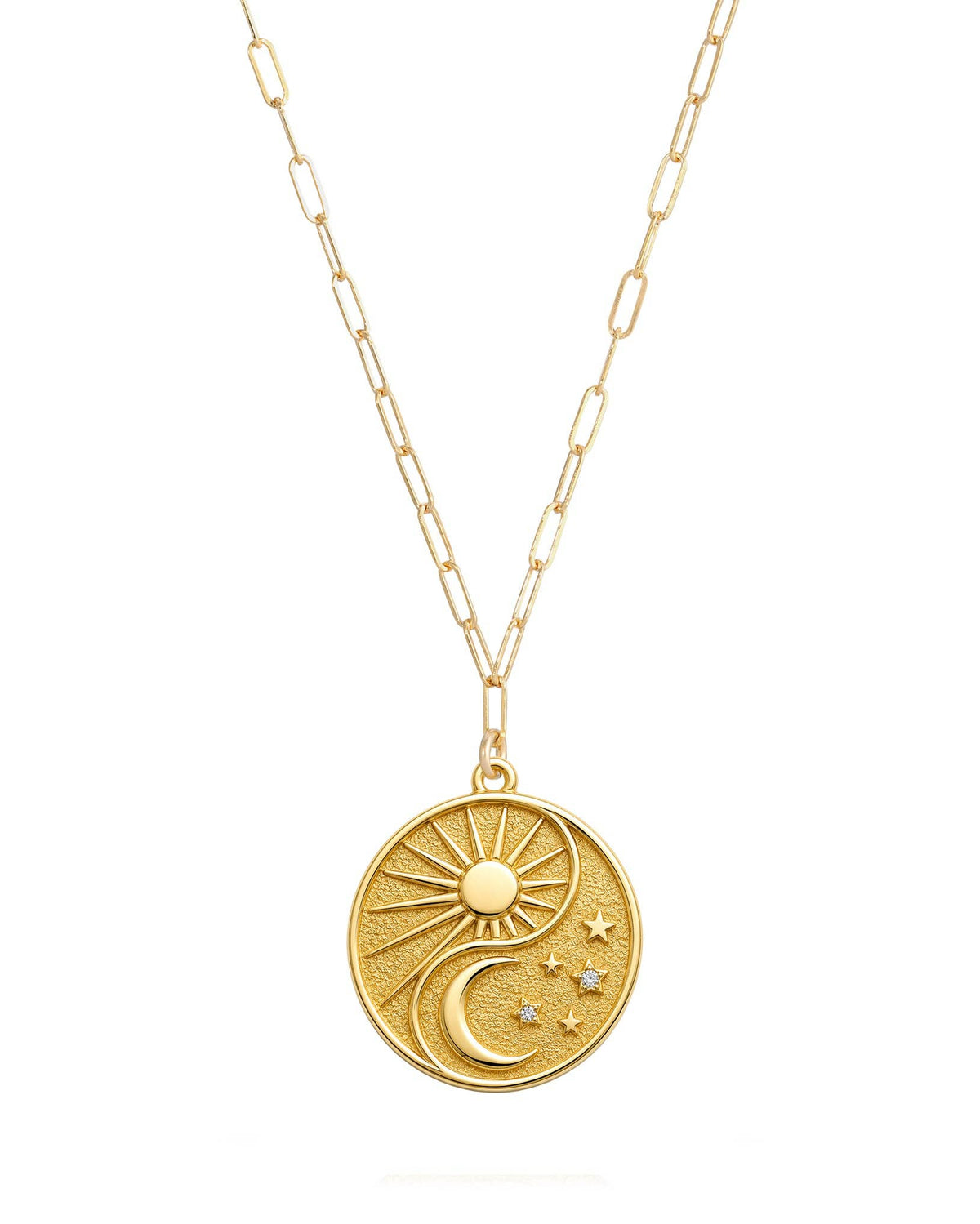 A gold chain necklace featuring a round pendant with a textured yin-yang design, including a sun, crescent moon, and small stars, shown against a plain white background.