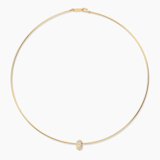 Gold necklace with a small pendant on a white background