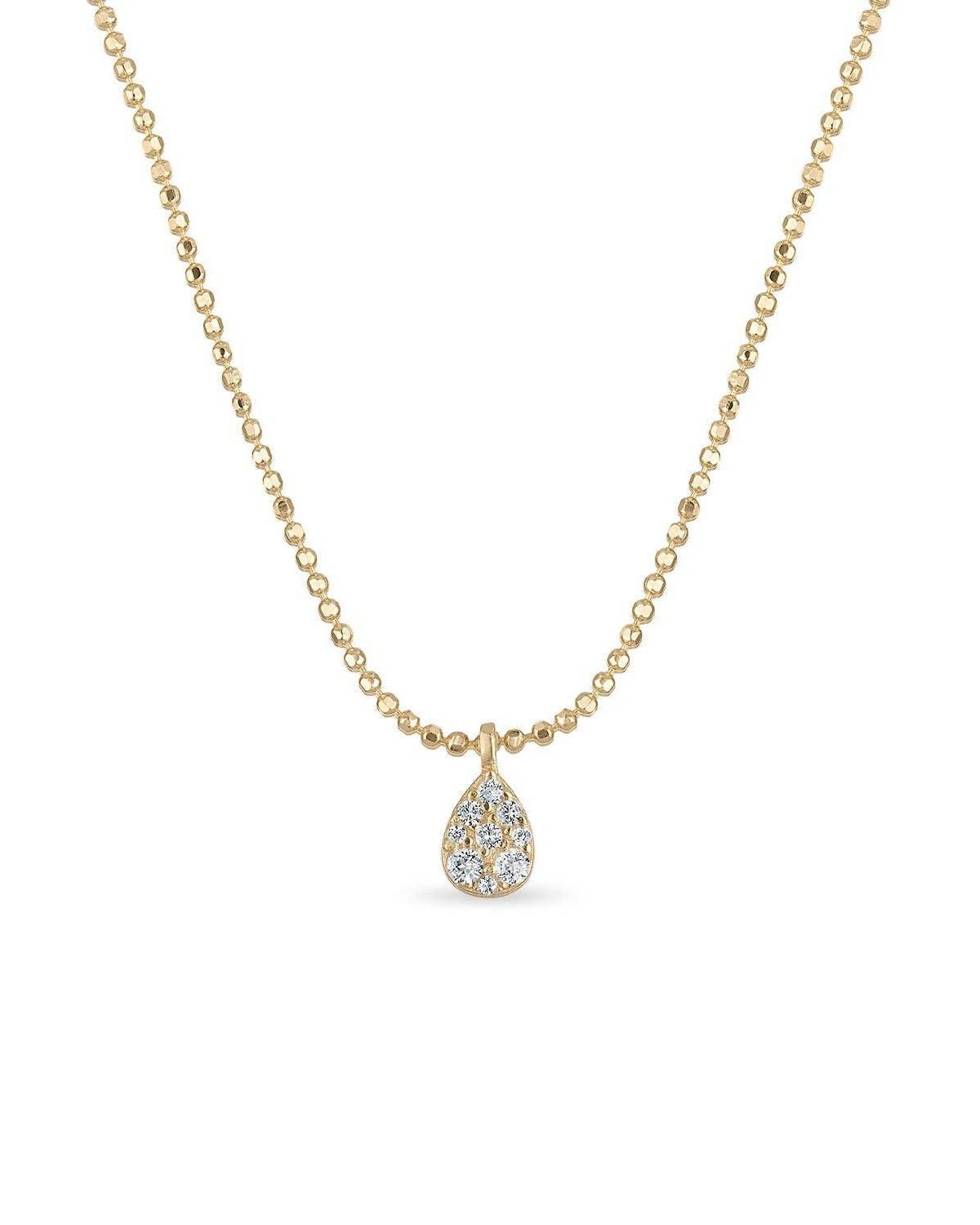 Gold necklace with a teardrop pendant on a white background
