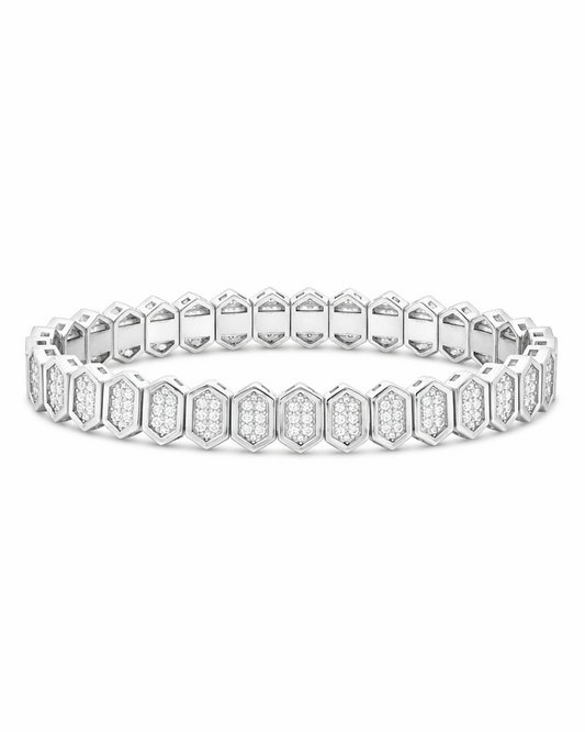 A silver-toned tennis bracelet featuring repeating hexagonal links paved with small clear stones, shown against a plain white background.