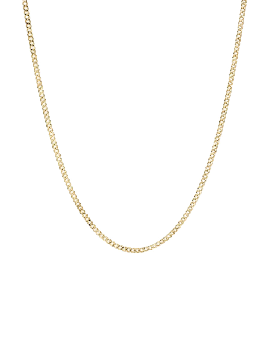 A delicate yellow gold chain necklace with a curb link design, displayed against a clean, light off-white background.