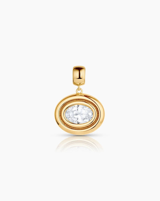 Gold pendant with a clear gemstone on a white background