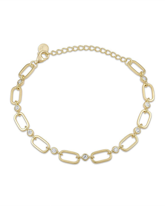 Gold bracelet with interlocking links and small crystals on a white background