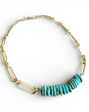 Necklace with turquoise beads and gold chain on a white background