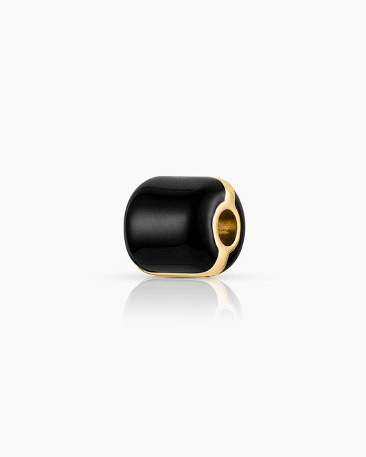 Black cylindrical beaded charm with gold accents on a white background