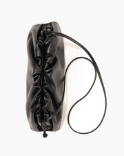 Black leather handbag with a strap on a white background