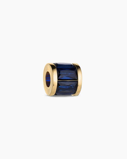 Gold ring with a blue gemstone on a white background