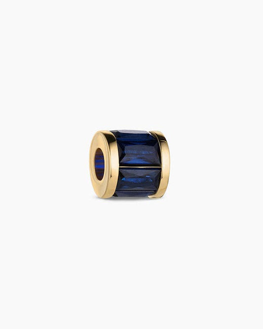 Gold ring with a blue gemstone on a white background