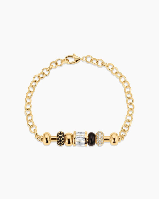 Gold bracelet with various colored beads on a white background