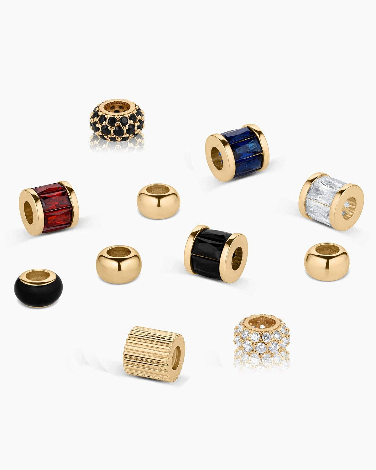 Collection of gold and multicolored beaded charms on a white background