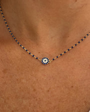 Necklace with a decorative pendant on a person's neck
