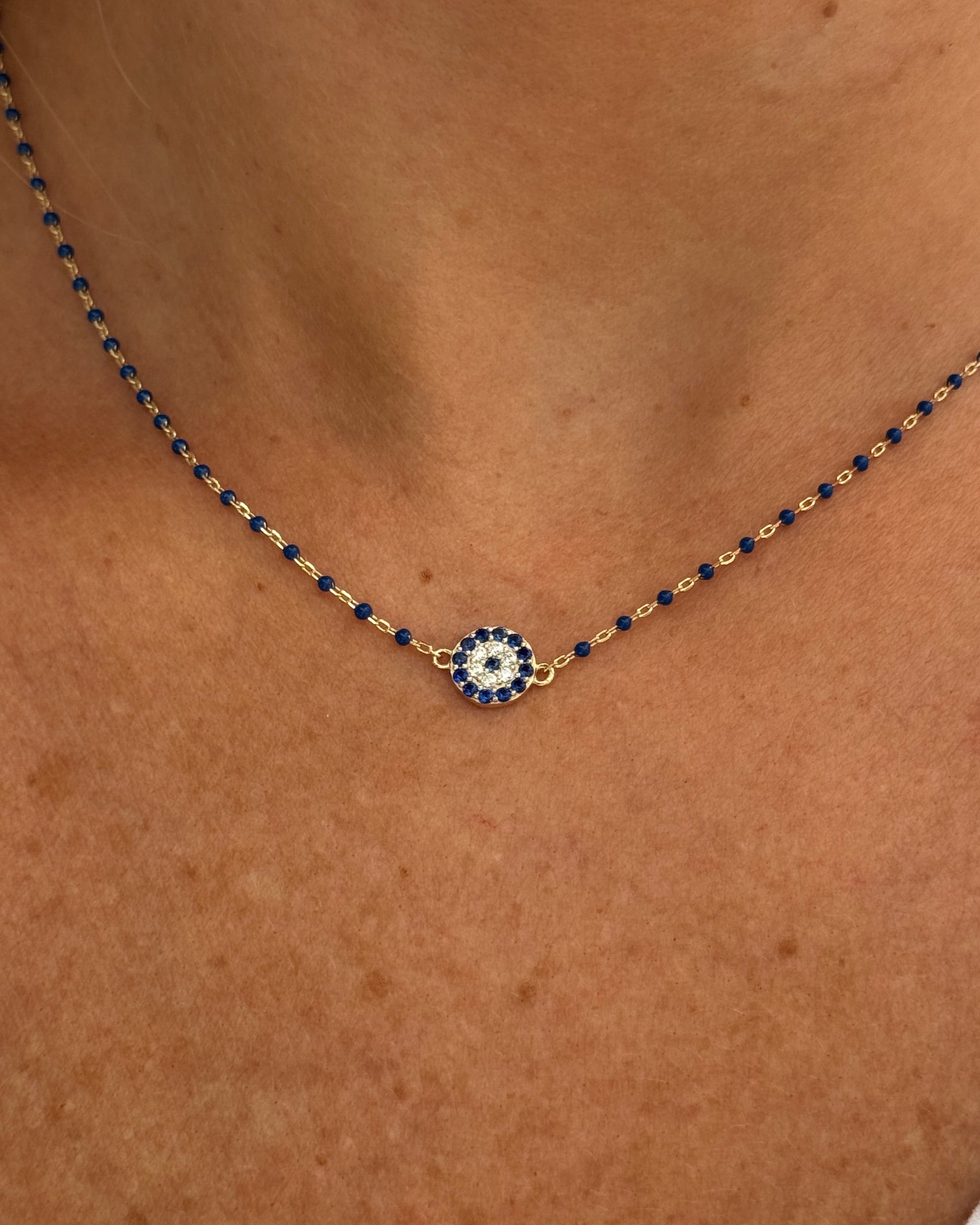 Necklace with a decorative pendant on a person's neck