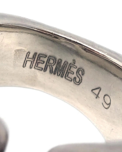 Close-up of a silver Hermès ring with size 49 engraving on a white background
