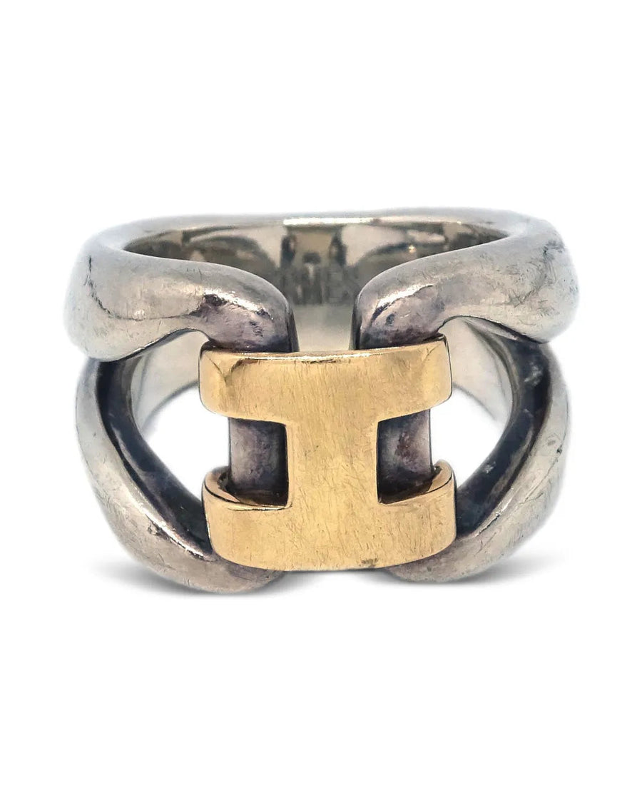 Two interlocking rings, one gold and one silver, on a white background