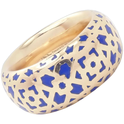 Gold ring with blue geometric pattern on a white background