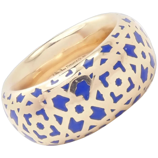 Gold ring with blue geometric pattern on a white background