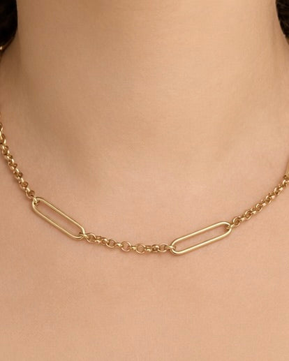 Gold chain necklace on a person's neck