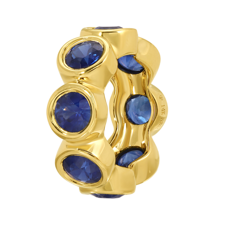 Gold ring with blue gemstones on a white background