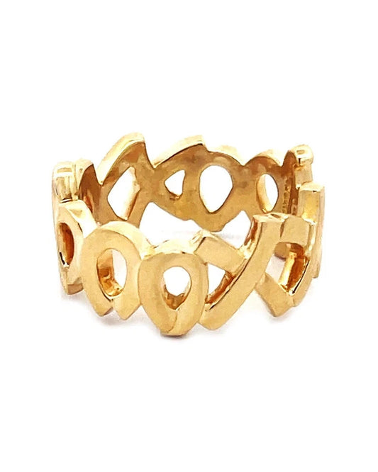 Gold ring with open design on a white background