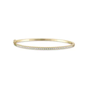 The MARNI Gold Diamond Turquoise Bangle by SKN, crafted from 14kt yellow gold vermeil, showcases a stunning row of small cubic zirconia stones and is reversible for versatile wear.