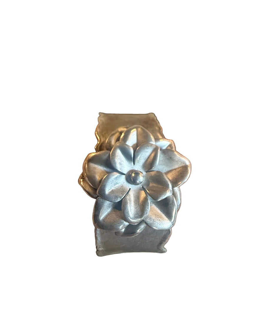 Metallic flower-shaped object on a white background