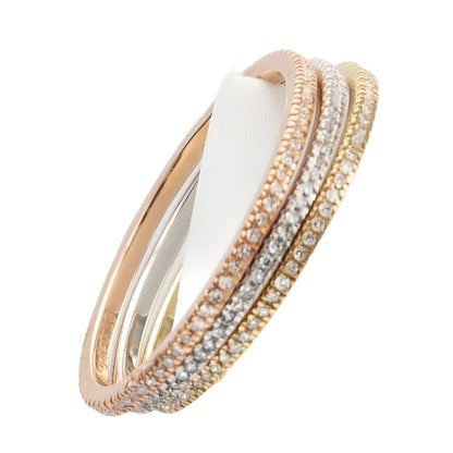 Three intertwined rings made of different metals: one rose gold with diamonds, one yellow gold **DYLANJAMES ADDIE 14kt Diamond Band Ring**, and one plain white 14kt gold ring, displayed on a white stand.